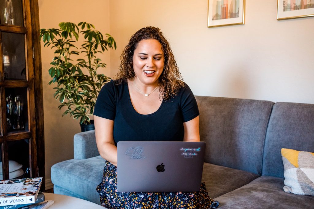 Jessica Meunier sitting on a couch with a laptop